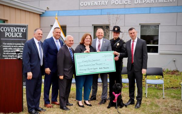 Reed and Magaziner present a large check to the Coventry Police Department