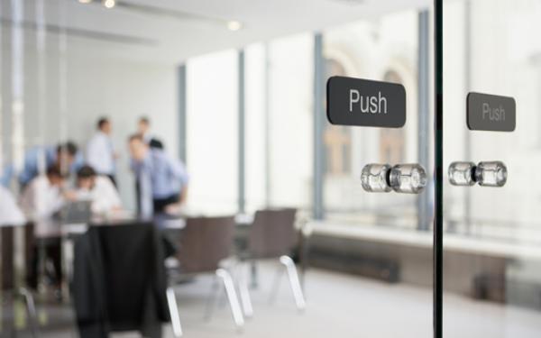 Office meeting behind glass doors