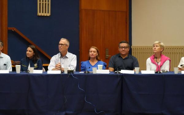 7 members of congress sitting at a panel