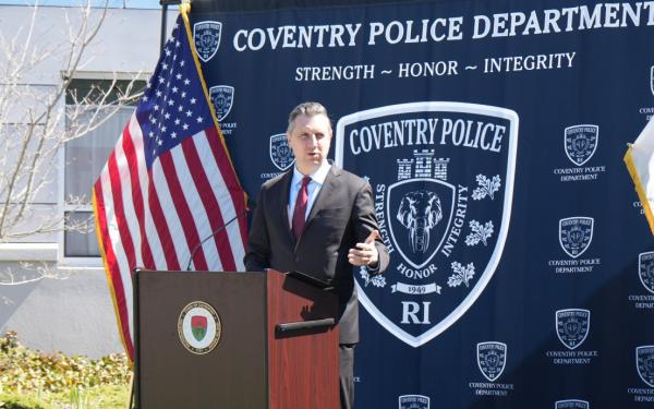 Rep. Seth Magaziner speaks at a podium. 