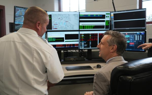Rep. Magaziner and Chief McMichael look at new equipment in the upgraded Warwick Emergency Operations Center. 