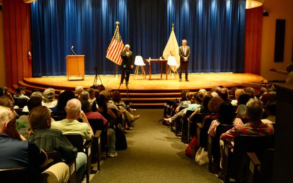 Reed and Magaziner stand in front of audience