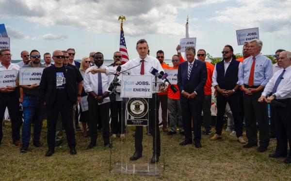 Magaziner speaking in front of crowd