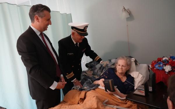 Magaziner and Chaplin present medal to woman