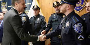 Warwick police officers are greeted and thanked for their dedicated service by U.S. Rep. Seth Magaziner, at left.