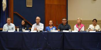 7 members of congress sitting at a panel