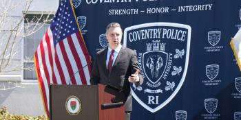 Rep. Seth Magaziner speaks at a podium. 