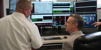 Rep. Magaziner and Chief McMichael look at new equipment in the upgraded Warwick Emergency Operations Center. 