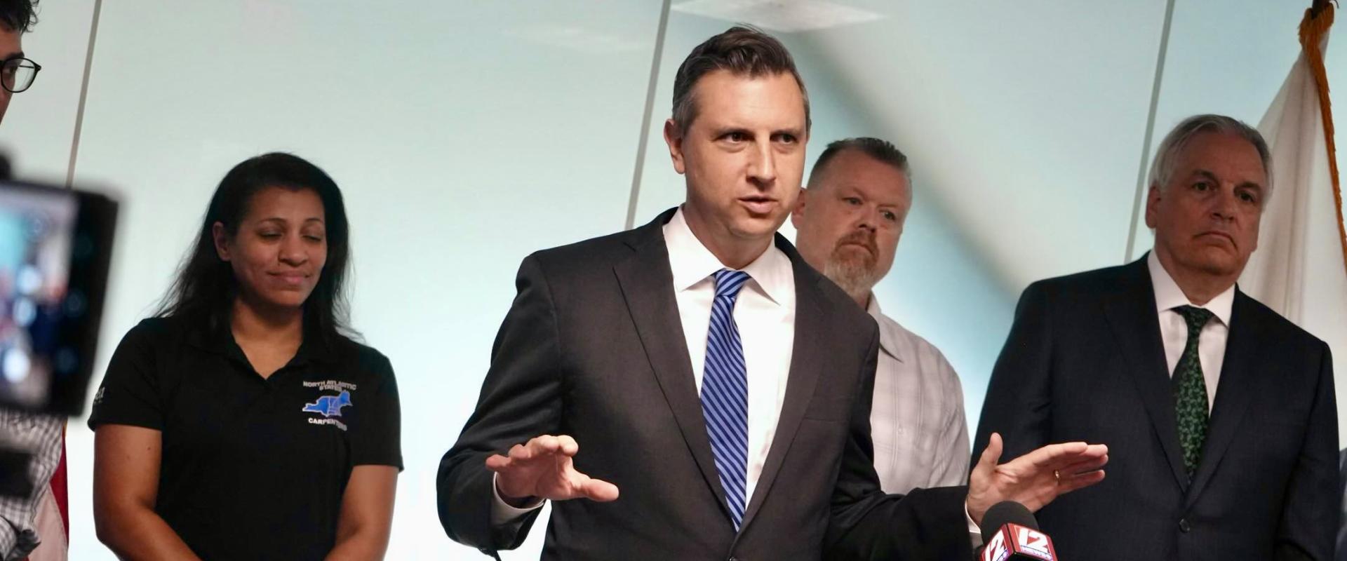 Magaziner speaks at press conference