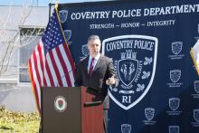 Rep. Seth Magaziner speaks at a podium. 