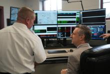 Rep. Magaziner and Chief McMichael look at new equipment in the upgraded Warwick Emergency Operations Center. 